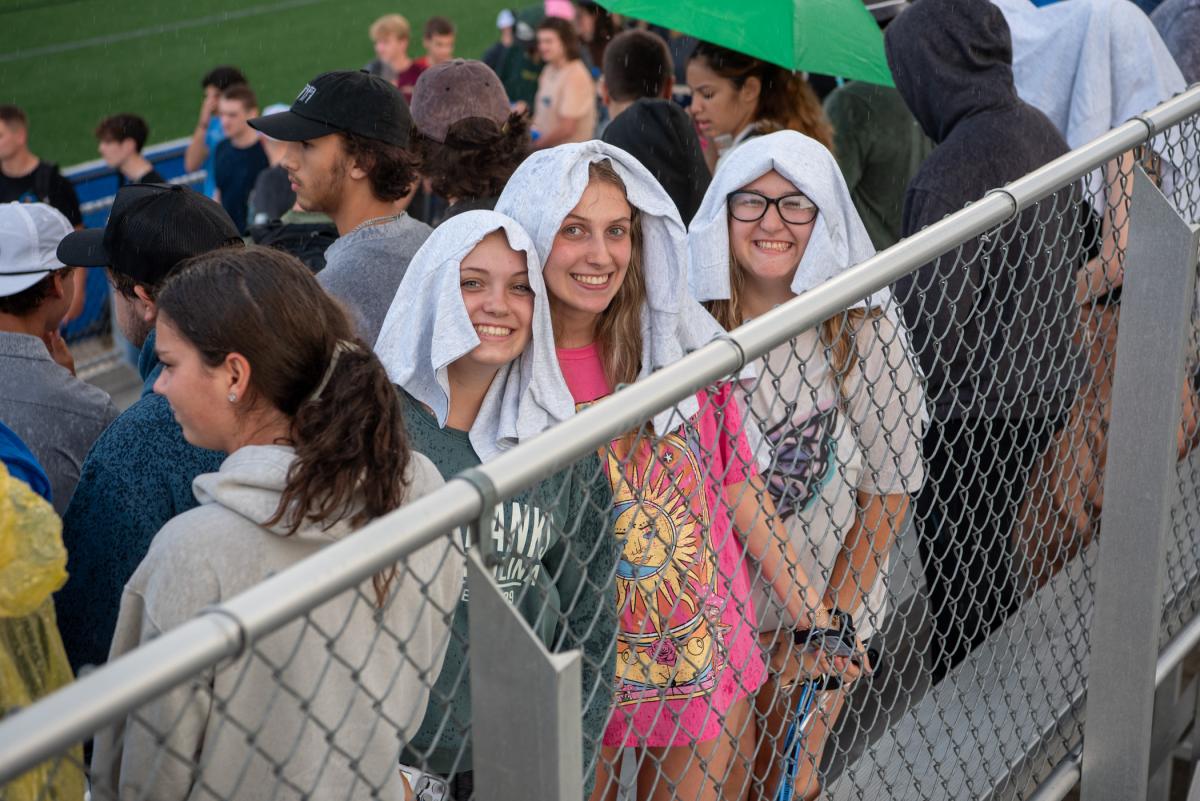 Putting those newly acquired giveaways to good use in the downpour
