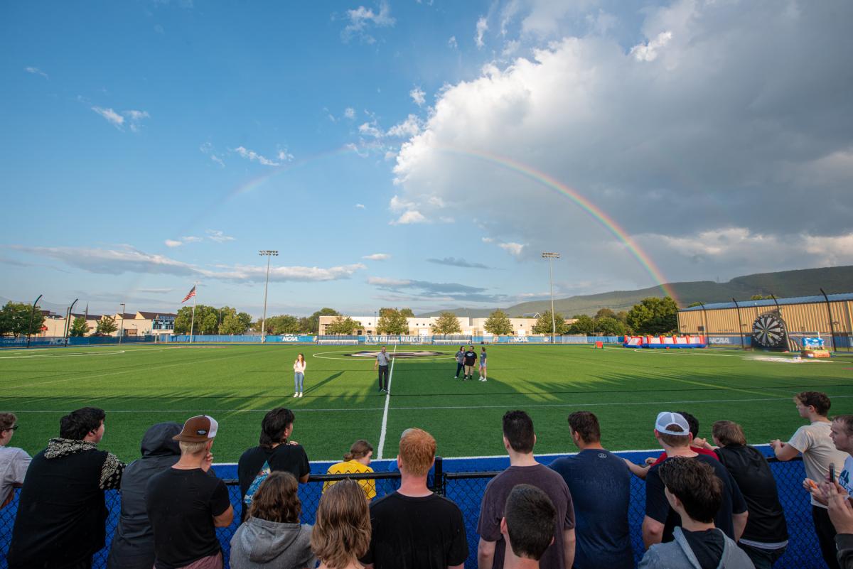 So good, it deserves an encore! Rainbow #2 frames the sudden sunshine of welcoming remarks. From left are American Sign Language interpreter Casey Thurber; President Reed; Allison Bressler Grove, director of student engagement; and orientation leaders Kellor A. Schooley and Eryn L. Nichols.
