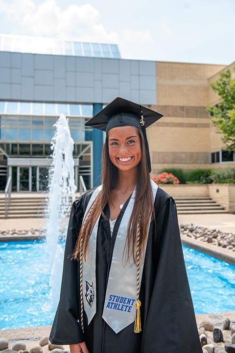 Wildcat soccer player Morgan Feeley, applied health studies: radiography concentration, strikes a refreshing pose at a campus fountain.
