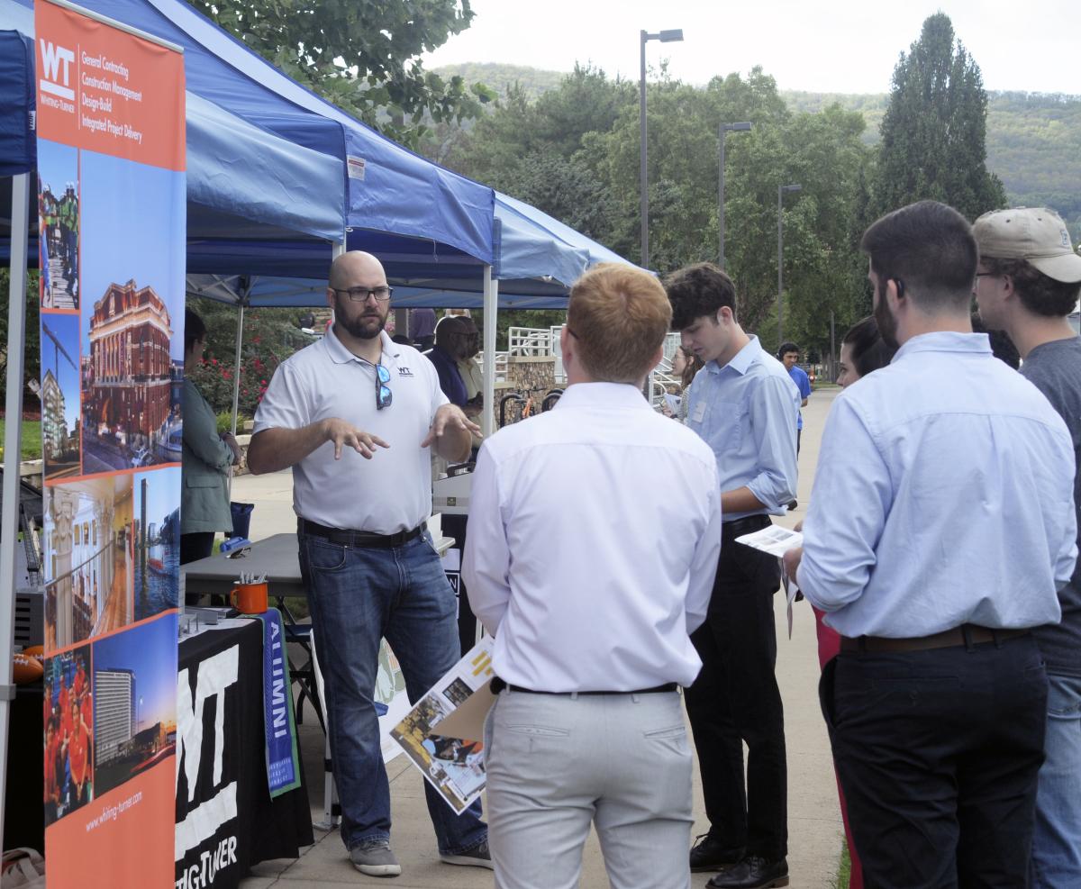 Alumnus William E. Hye, ('16, construction management), a project manager with the Whiting-Turner Contracting Co., draws a crowd of potential interns.