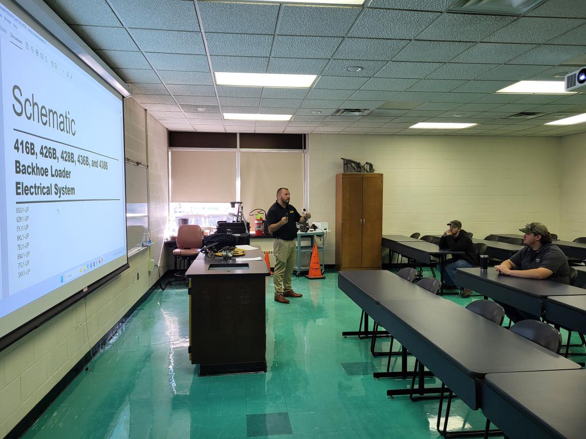Former faculty member John D. Motto, now a service training manager for Milton CAT in Massachusetts, returns to the classroom for a lesson in schematics.