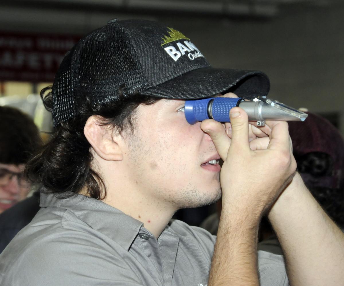 As part of a Cleveland Brothers activity, Isaac C. Cory uses a refractometer to test Diesel Exhaust Fluid quality. Cory, the Wildcats' first-ever Division III national qualifier in wrestling, is working toward an associate degree in electric power generation technology: diesel emphasis.