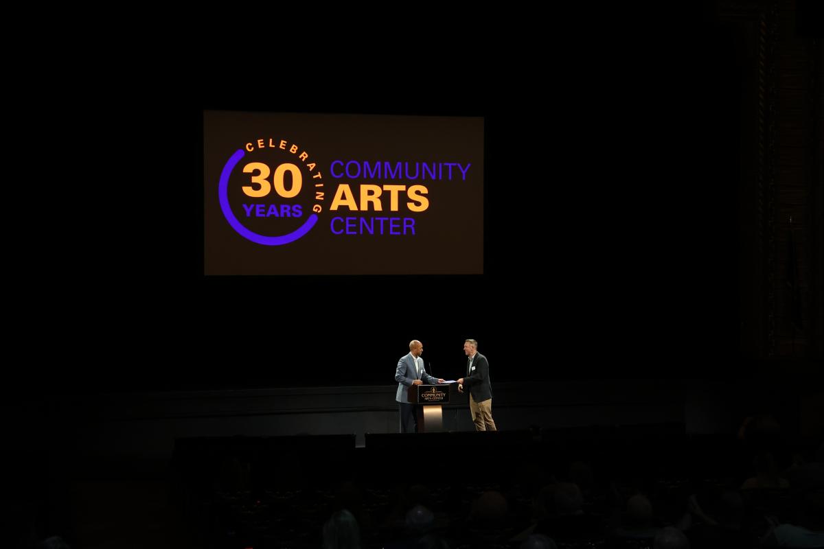 Mayor Slaughter hands Dougherty a copy of the proclamation championing the CAC's "mission to provide exceptional arts and entertainment to the diverse needs of its regional audience." (Photo by Steven M. Ault, manager of marketing communications)