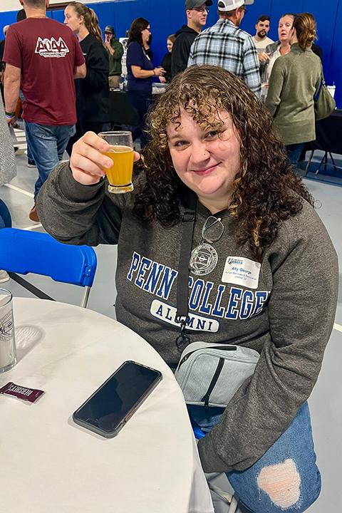 Ally M. George ’22, human services & restorative justice, cheers a successful alumni evening.