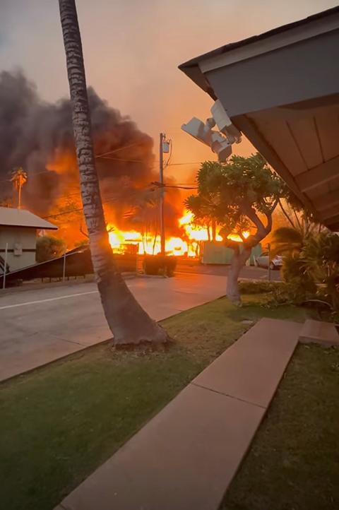 The proximity of the encroaching flames to the Pattersons' home is dramatically illustrated in this photo, taken by a neighbor as Kristen fled with her cats.