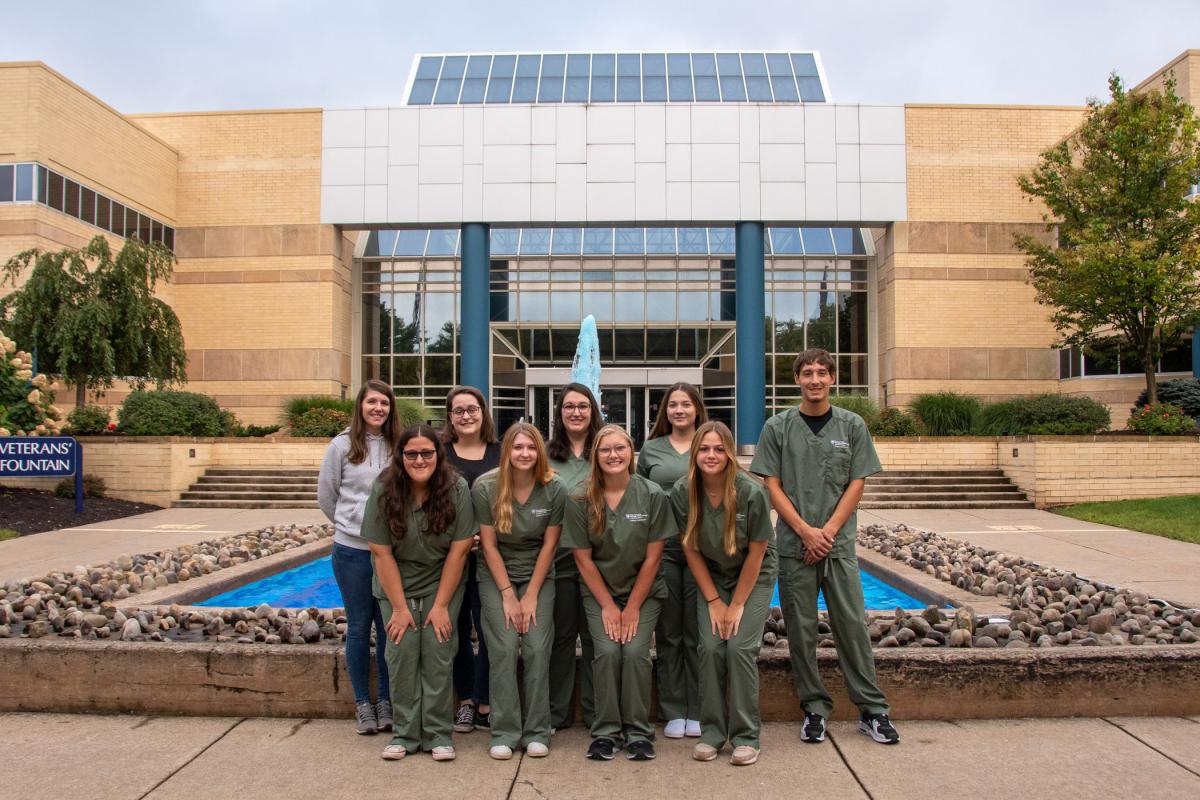 Students mark National Surgical Technologists Week in a celebratory group photo at the Veterans' Fountain.