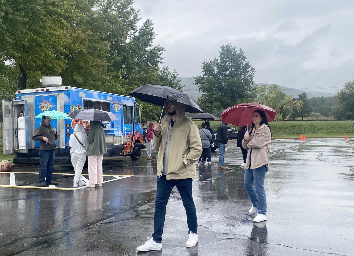 Toting umbrellas and dodging puddles in the parking lot 