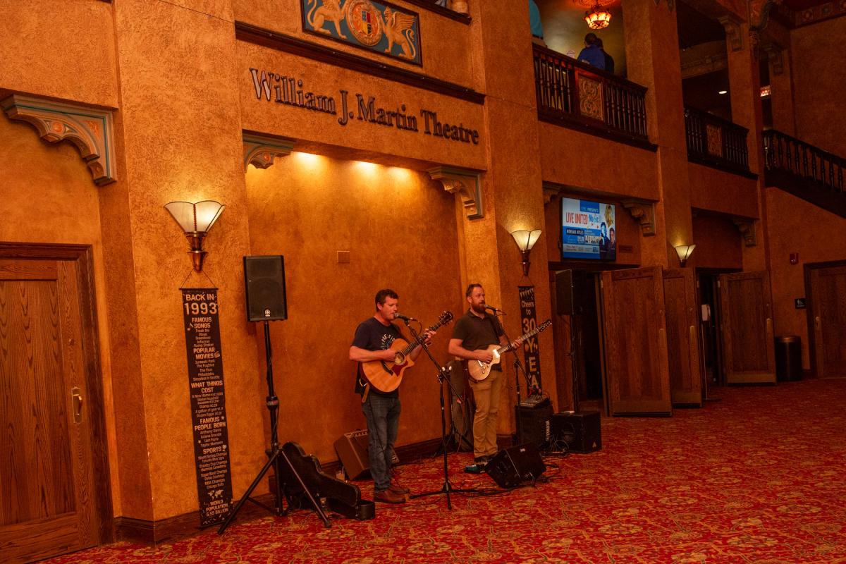 … while being entertained by local musicians David Lynn (left) and Sean Farley. 