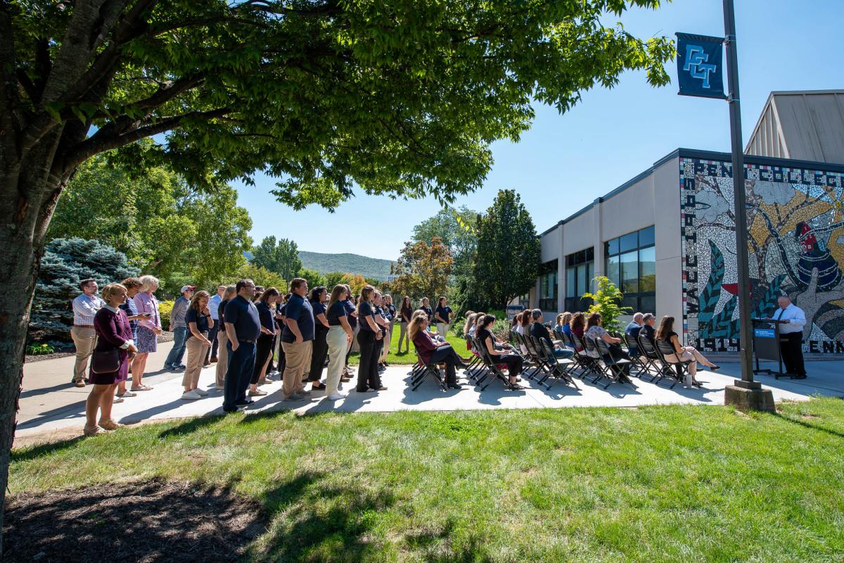 Students, special guests and employees gather outside the Physician Assistant Center at Pennsylvania College of Technology to hear remarks by Joshua A. Bower (at podium at right), director of the physician assistant program, at the start of an open house celebrating recent renovations to the center. 
