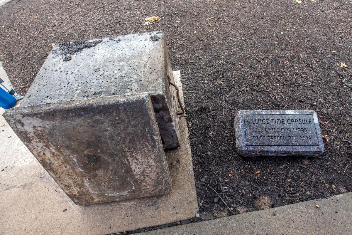 Earlier, the time capsule that had been buried in this spot was dug up with the coordination of Chad L. Karstetter, horticulturist/grounds and motorpool manager. Nicole S. Warner, librarian, archives and special collections, assisted with salvaging some of the items that were “soaking wet” in the vault so that they could be shared at the unveiling.