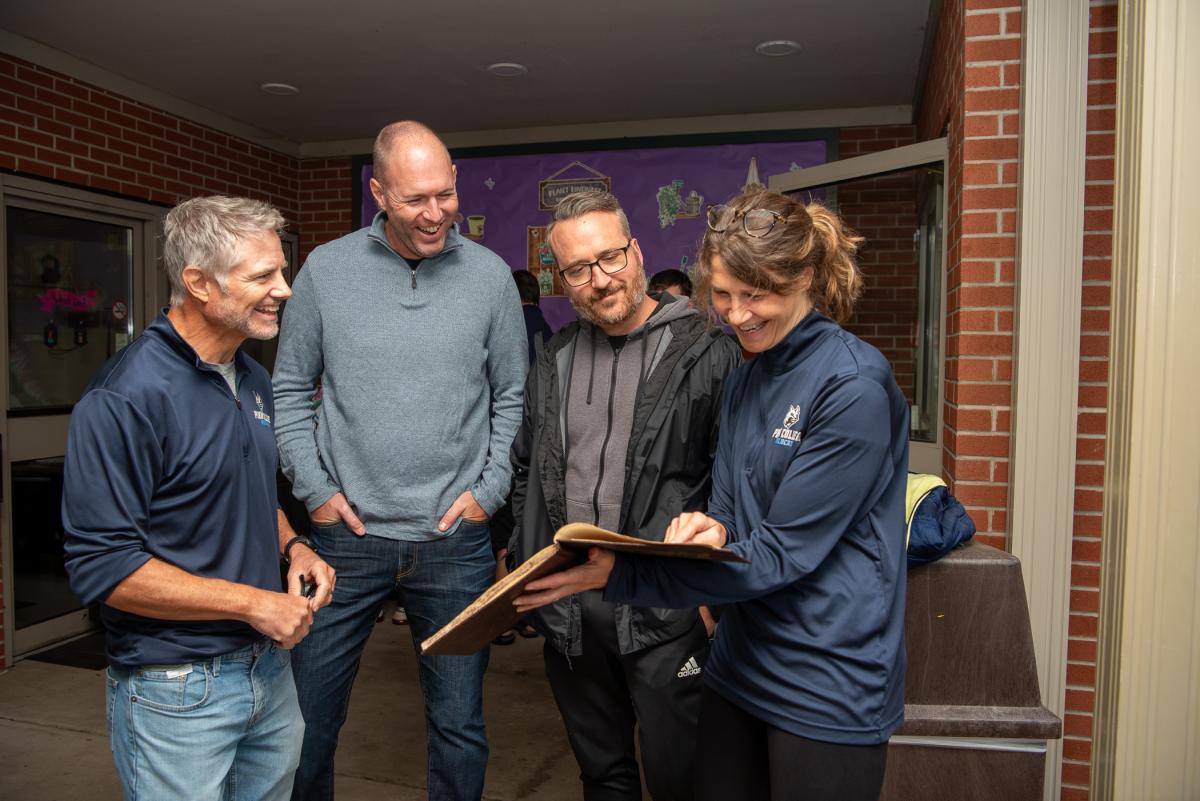 Mallery and the Mackeys enjoy a trip down memory lane along with Kevin L. Imes (second from left). Imes holds degrees in building construction technology (2003) and construction management (2007).