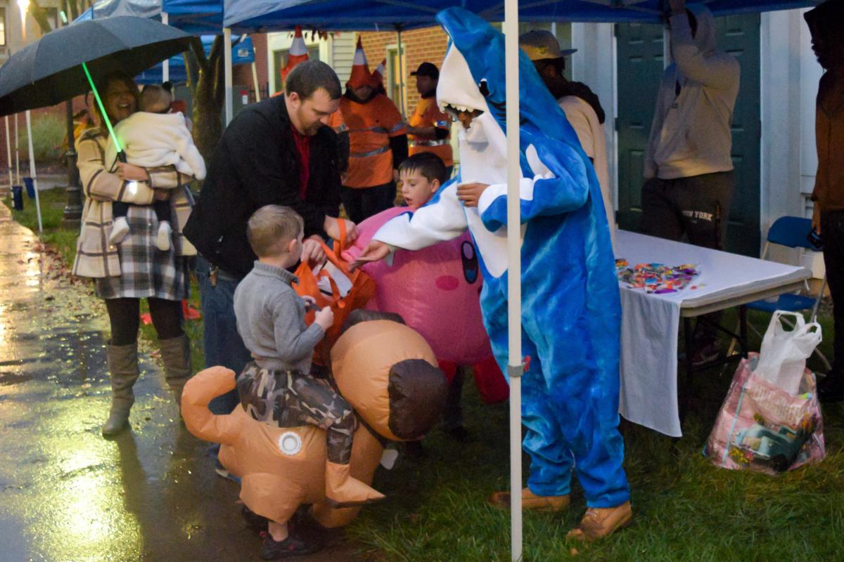 A land shark, coming ashore in the puddling rain, adds to some youngsters' candy collection.