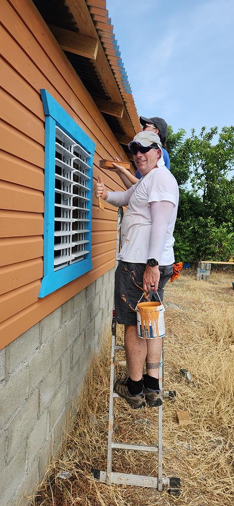 Cooley signals his satisfaction with a paint job well underway on the residential build.