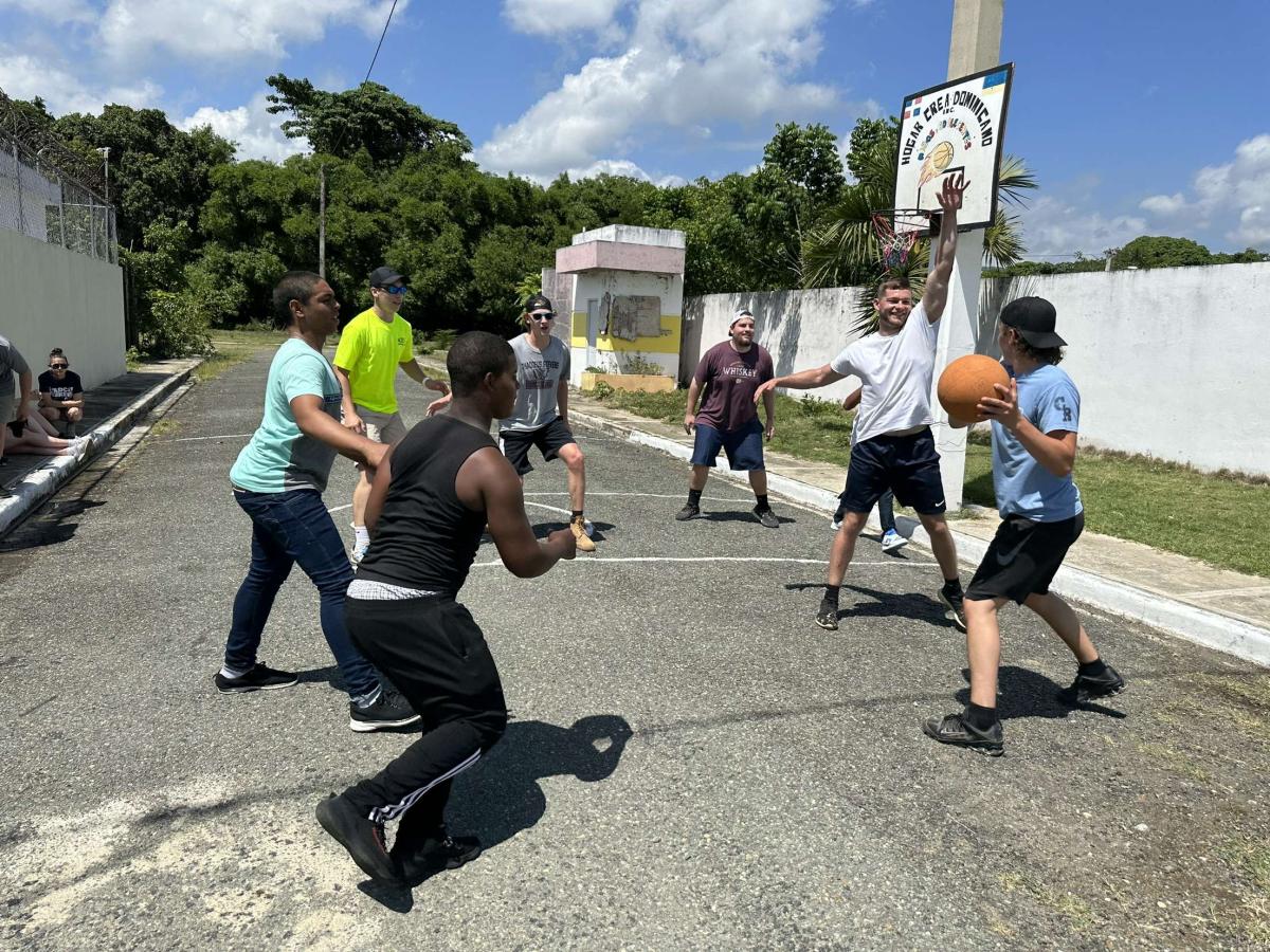 Students play basketball with some of the youths at a local rehab center.