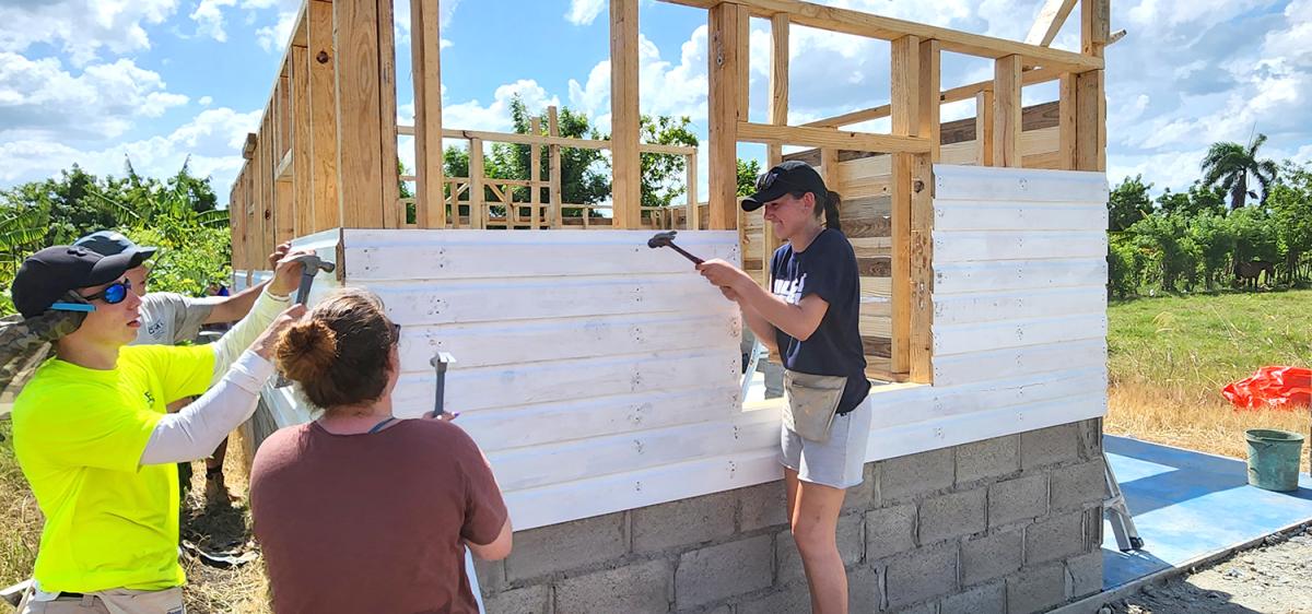 Members of a Pennsylvania College of Technology team, on a Global Experiences visit to the Dominican Republic, nail up the wooden siding on what will be a family’s home. Two faculty members and 21 students, representing programs in all three of the college's academic schools, took part in an eye-opening mission trip that also delivered life-altering water filters to communities. 