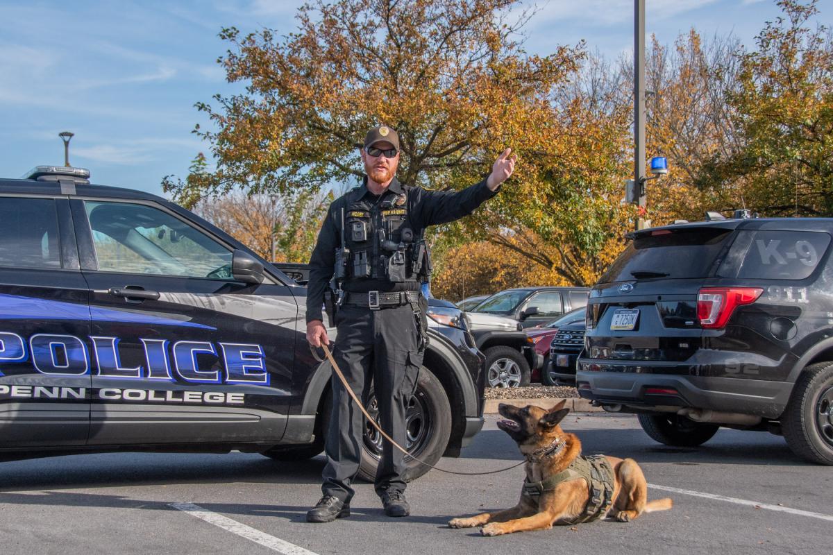 Niko waits attentively while McGee discusses his ability to detect and track. The two have worked together for three years.