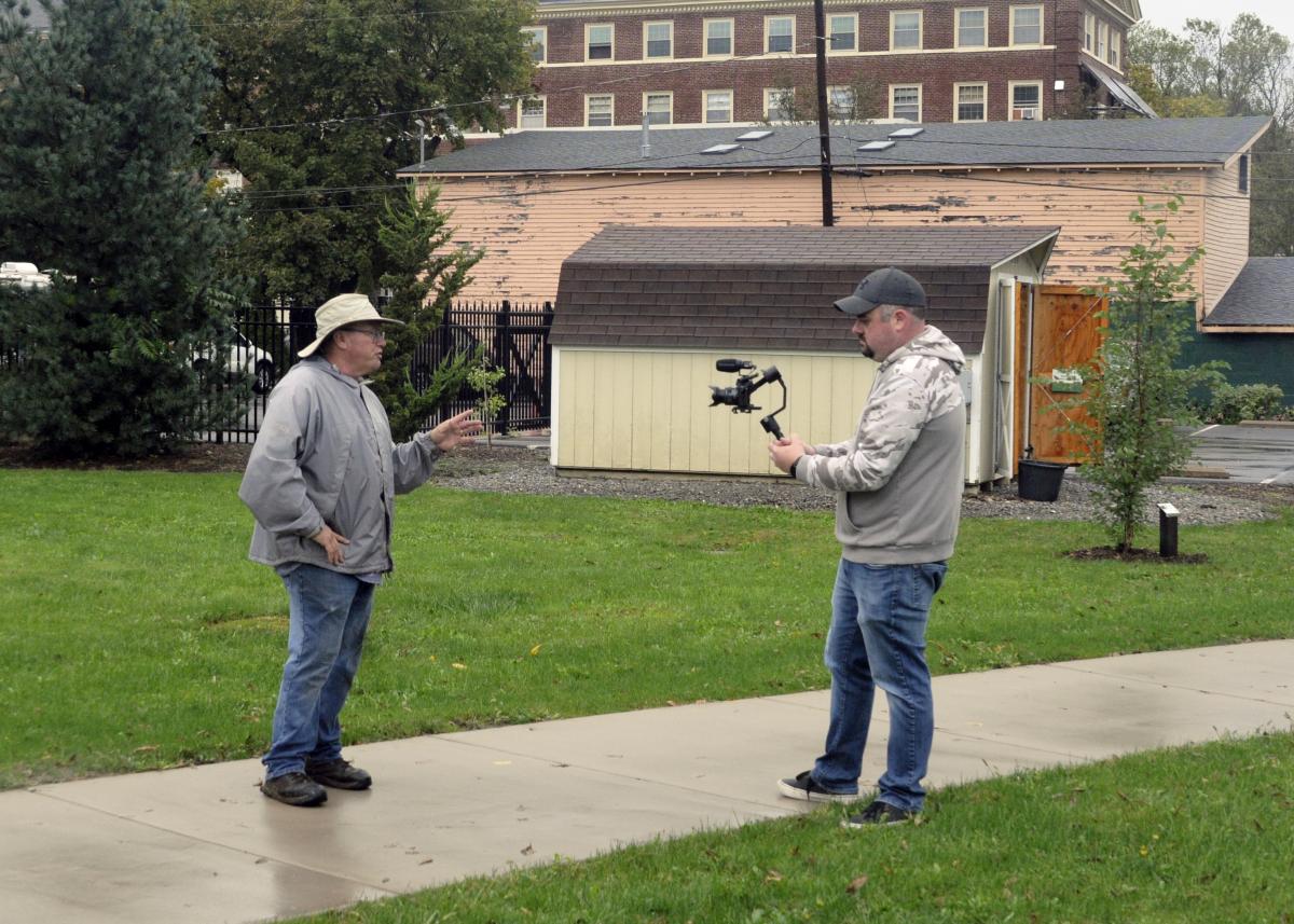 Horticulture Club adviser and Ways Garden commissioner Carl J. Bower Jr. talks about the park's history with Nate Losell, a freelance videographer documenting the afternoon event. Having such a hands-on role in maintaining the garden gives Bower an inside track on educational opportunities, he said. "This is also a perfect venue for the students to help beautify the community, and learn about nature, gardening and sustainability." 
