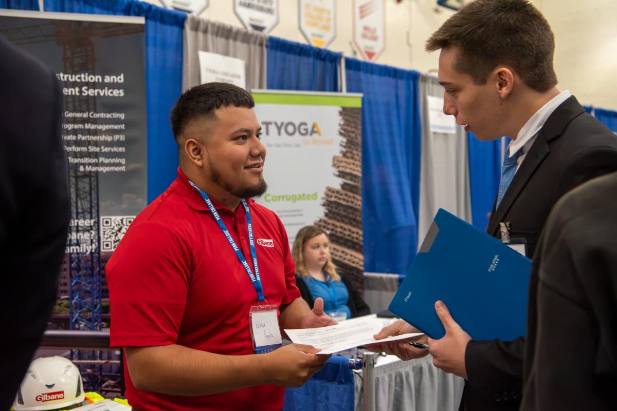 Resume received! Gilbane Building Co.’s Nestor Y. Ayala (left), ’22, construction management, provides a welcoming touchstone for such current construction management students as Chris A. Fisher. 