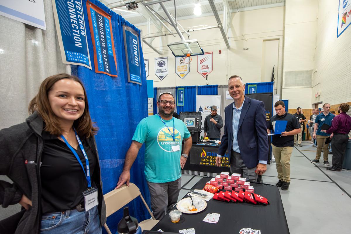 President Michael J. Reed stops by the Lycoming Engines table to visit with Joel Harding (center), IT manager, and Noelle Selden, human resources business partner. Harding says he’s looking to hire IT professionals – and notes that 50% of his team is comprised of Penn College graduates.