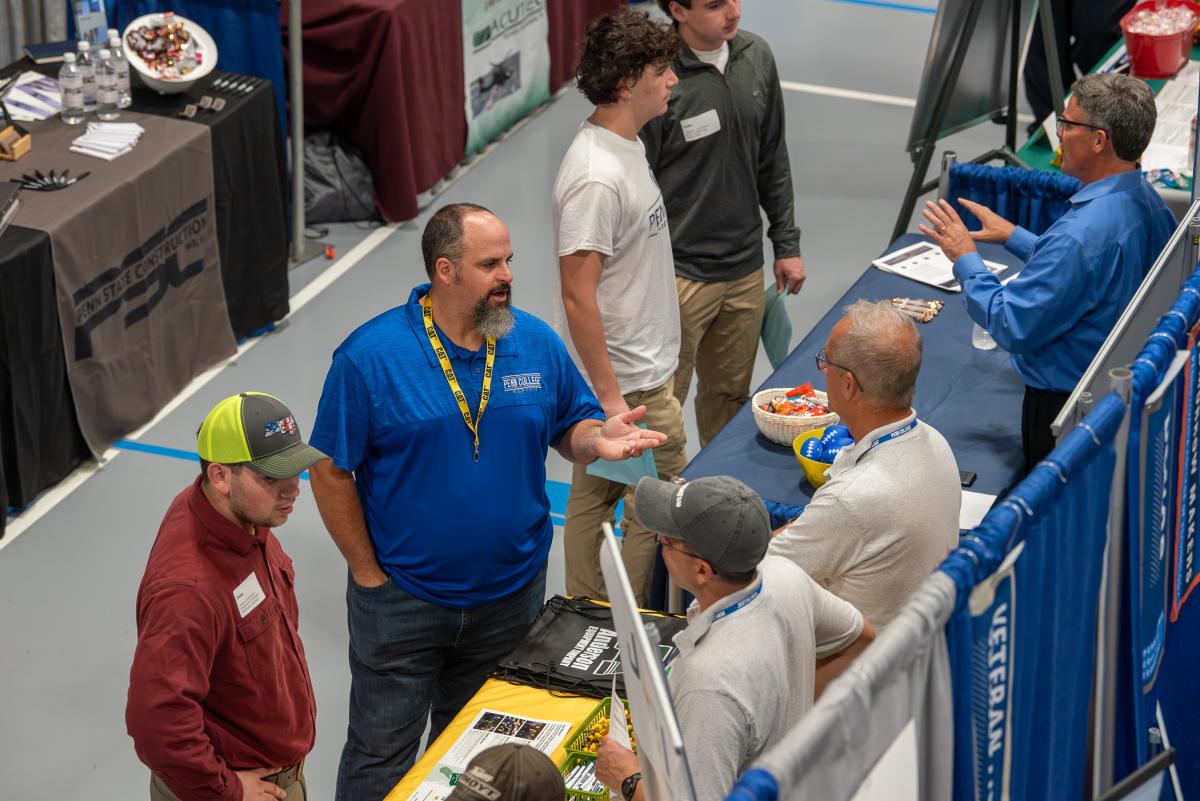  Students aren’t the only ones making connections; faculty take full advantage of the networking opportunities, too! Here, diesel instructor and two-time alumnus Brad R. Conklin, '00 and '19, chats up Anderson Equipment Co. reps.