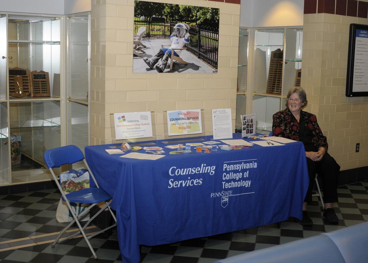 Counseling Services' Linda L. Locher staffs a pop-up table in the Bush Campus Center, offering vital support and encouragement to first-generation students.
