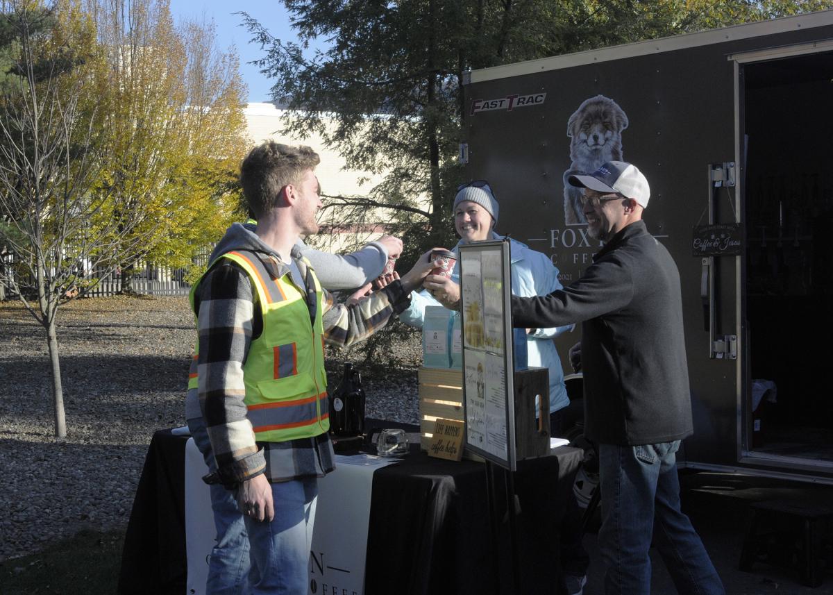 Erin and Todd Fox (a 1998 business management alumnus), owners of Fox Den Cold Brew Coffee, serve a pair of students who stopped by "The Rock" on Monday from a nearby surveying class.