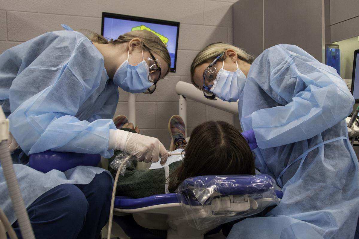 KyLeigh L. Alexander (left), of Portage, and Julie K. Wangler, of Lancaster, engage their young patient in conversation as they provide care.