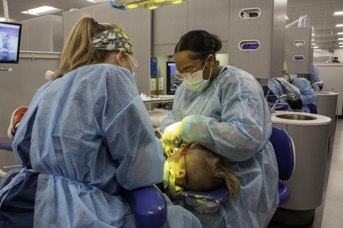 Sarah L. Acel (left), of Franklin, and Lauryn T. Watson, of Elkins Park, apply sealants.