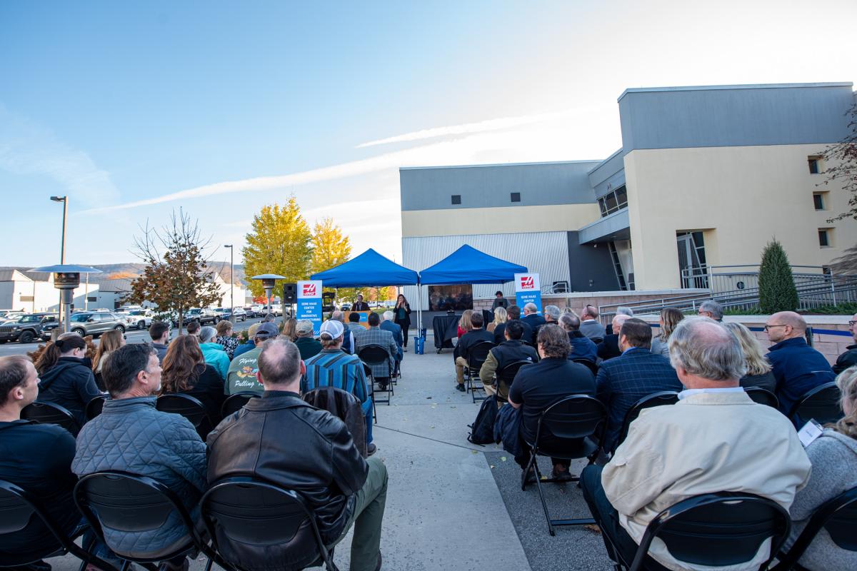 Patio heaters were on-site to cushion the chill, but one couldn't ask for a more hospitable November day! Bradley M. Webb, dean of engineering technologies, is at the podium; signing his remarks is Heidi E. Roupp, disability and access resources specialist/staff interpreter.