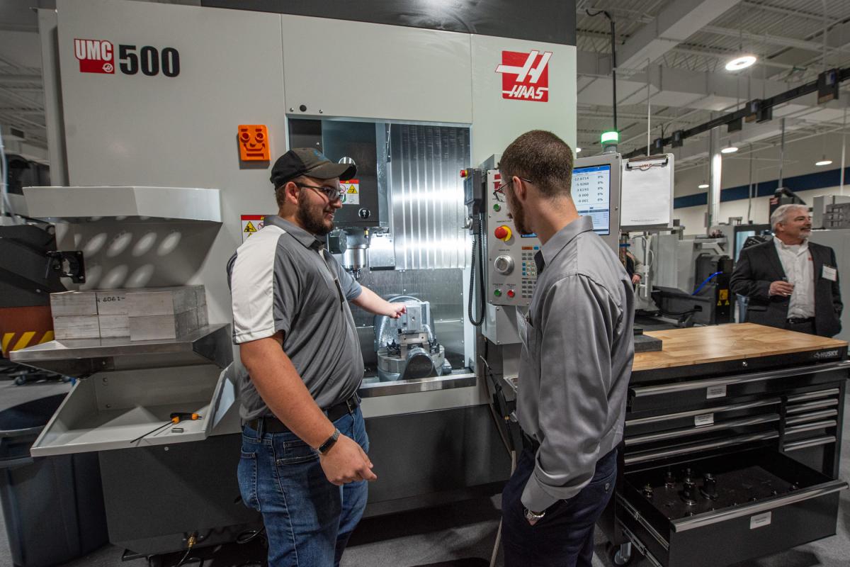 Brian P. Rogers, automated manufacturing technology, shows off the Haas UMC 500 to alumnus (and former member of the college's winning Baja SAE team) Dakota C. Harrison, ’22, manufacturing engineering technology and automated manufacturing technology.