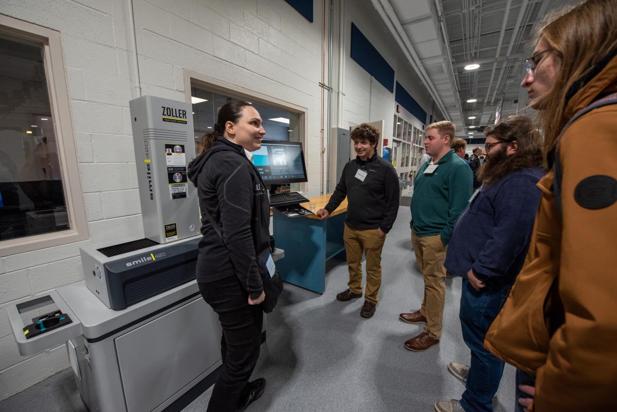 Students look on as Emily Brunnschweiler (left), sales engineer with ZOLLER Inc., discusses features of the ZOLLER smile Pilot 4.0 presetter, recently provided to the college at a discounted rate.