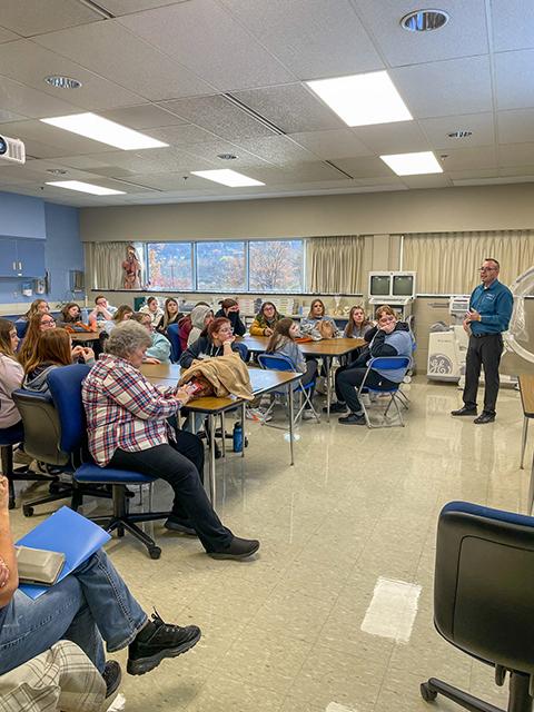 Geist talks with visiting students about the field of surgical technology.