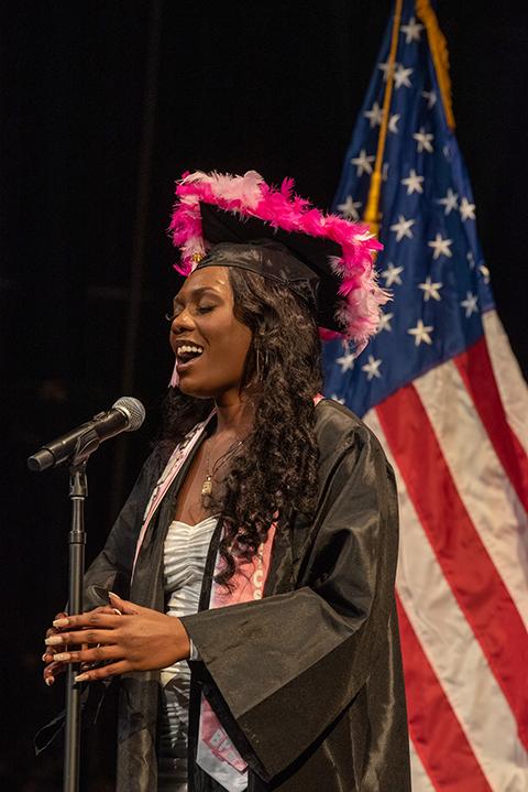 Sharing her vocal talents, Coryn Aliyah Oswald sings the national anthem prior to accepting her degree in plastics & polymer engineering technology.