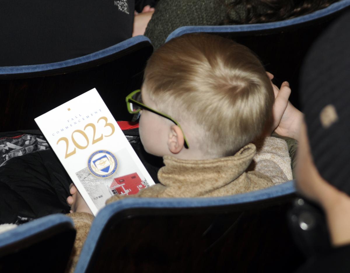While many his age would fuss and fidget, this young man sat – program in hand – attentively watching for his favorite graduate.