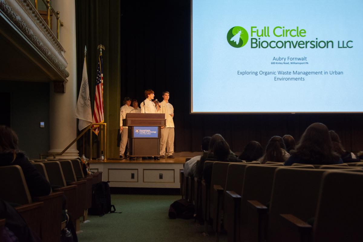Culinary arts technology student Noah W. Beck, of Port Matilda (with microphone), joins project partner Daniel S. Gray (right), of Millheim, to share insights from the Introduction to Sustainable Food Systems course. 