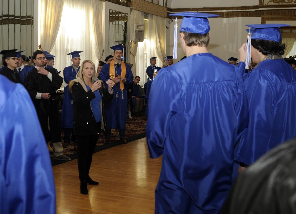 Just before dismissing near-grads for their march up West Fourth Street, Registrar Maria N. Piselli provides last-minute instructions in a Genetti Hotel ballroom.
