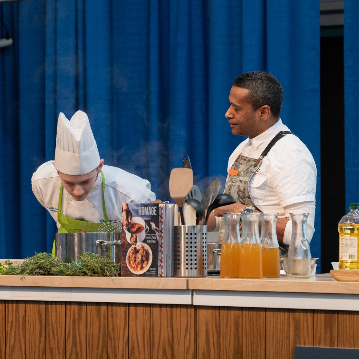 Culinary arts technology student Nicholas P. Matz, of Schuylkill Haven, is encouraged to catch the aroma of a recipe-in-progress as he assists Chef Chris Scott (right), a finalist on Season 15 of Bravo’s “Top Chef” television series and a judge on “Beat Bobby Flay.”