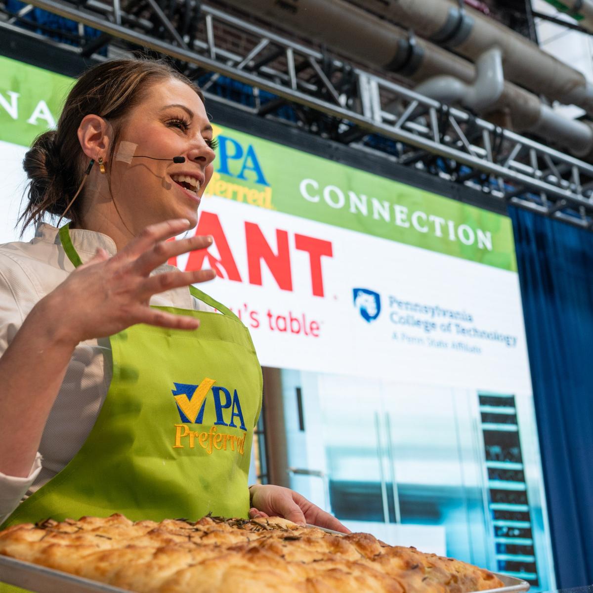 Alisha Howell Summa, a 2012 Penn College baking & pastry arts grad, talks the crowd through her recipe for focaccia. Summa owns Lynn Sandy’s Bakery in Scranton.
