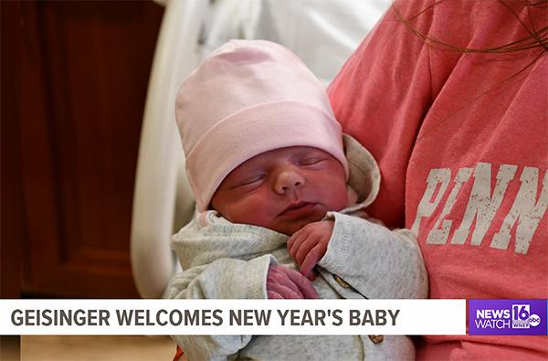 Felicia E. Rindos wears a Penn College T-shirt in media interviews with her husband and newborn daughter.
