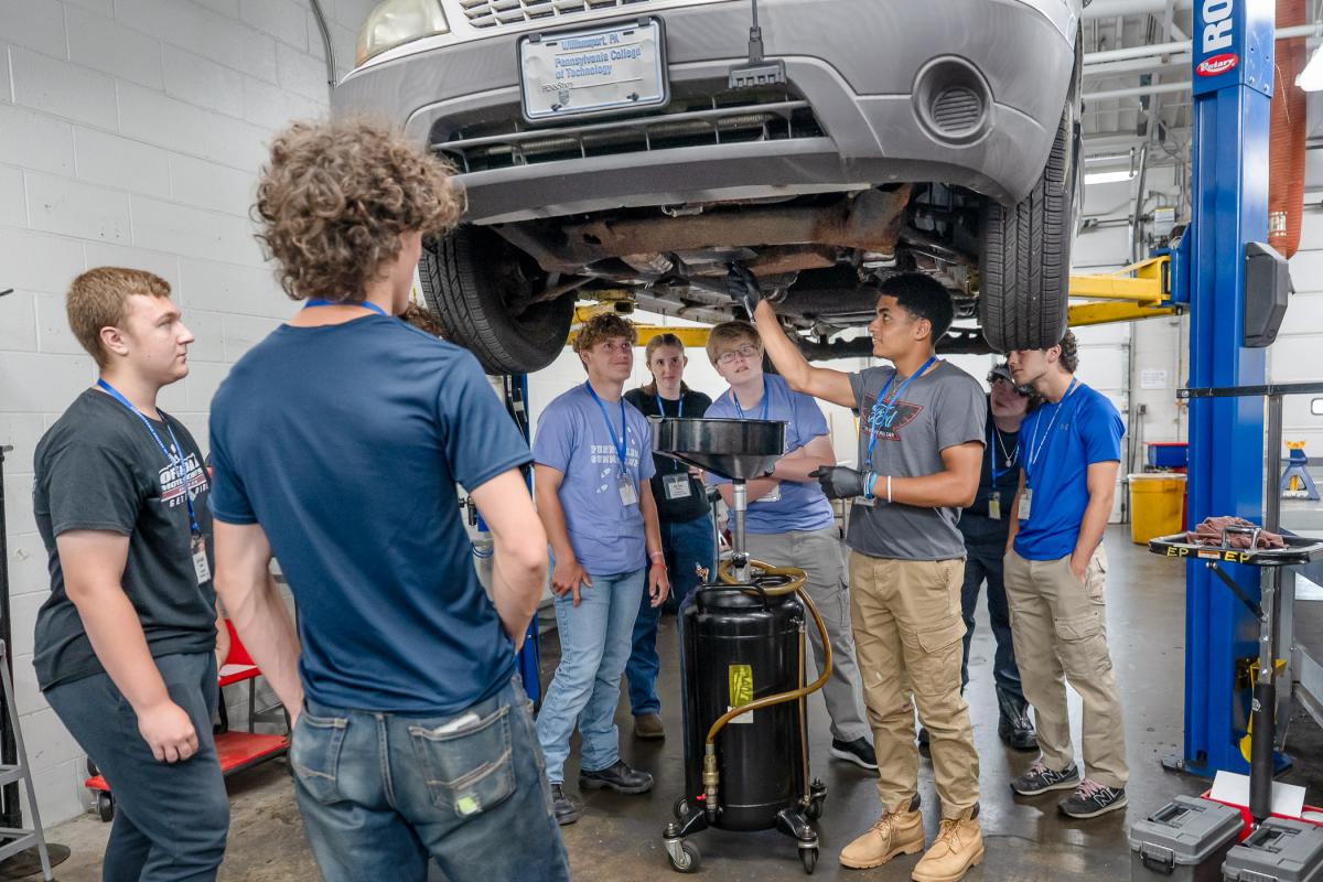Teens surround a vehicle