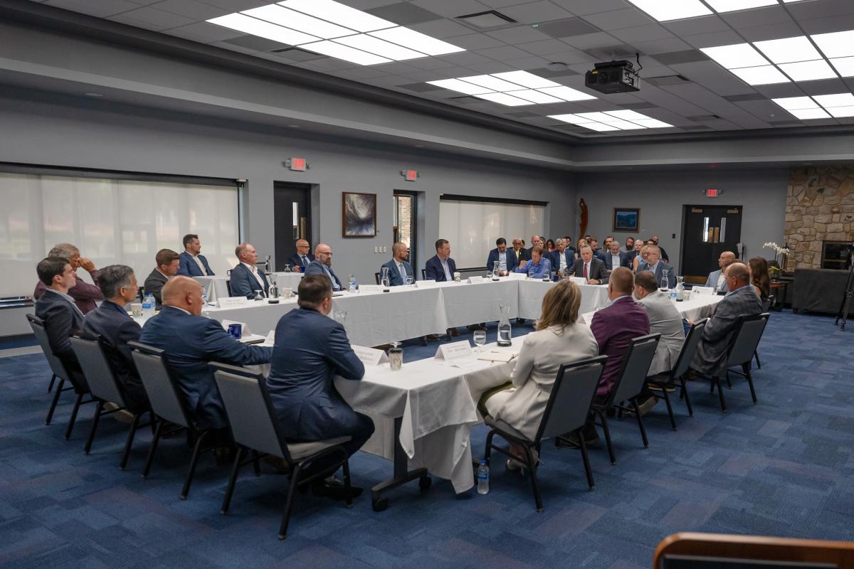 People in business attire sit around a conference table in the Pennsylvania College of Technology Thompson Professional Development Center.