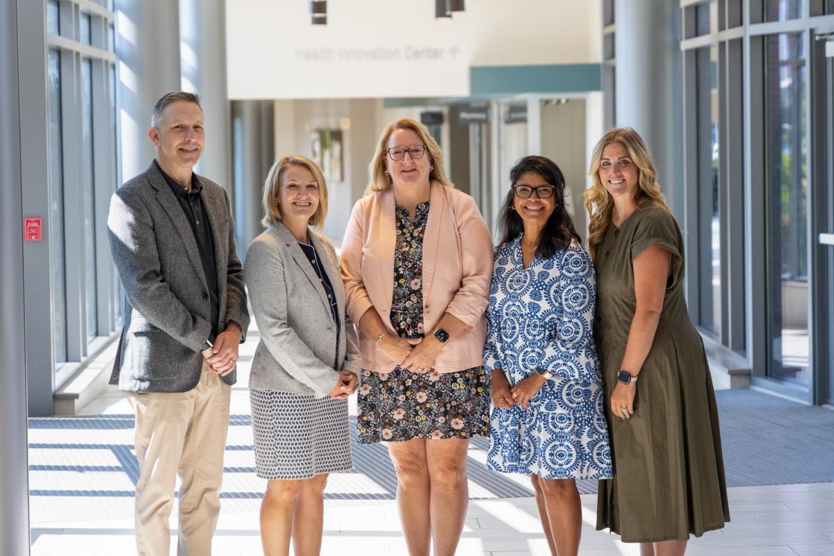 A group of people gathers in a brightly lit lobby at UPMC Williamsport.