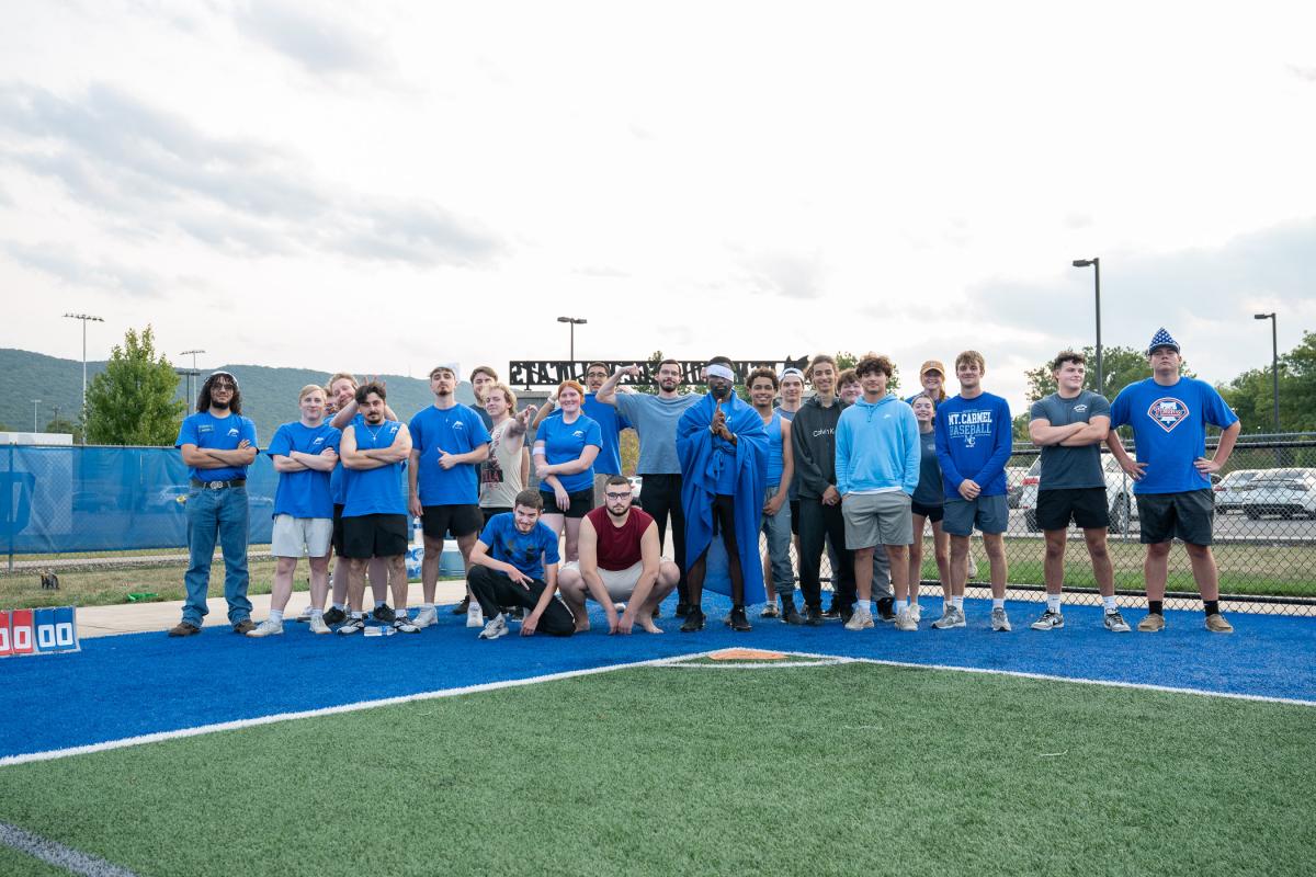 A group of students in blue shirts.