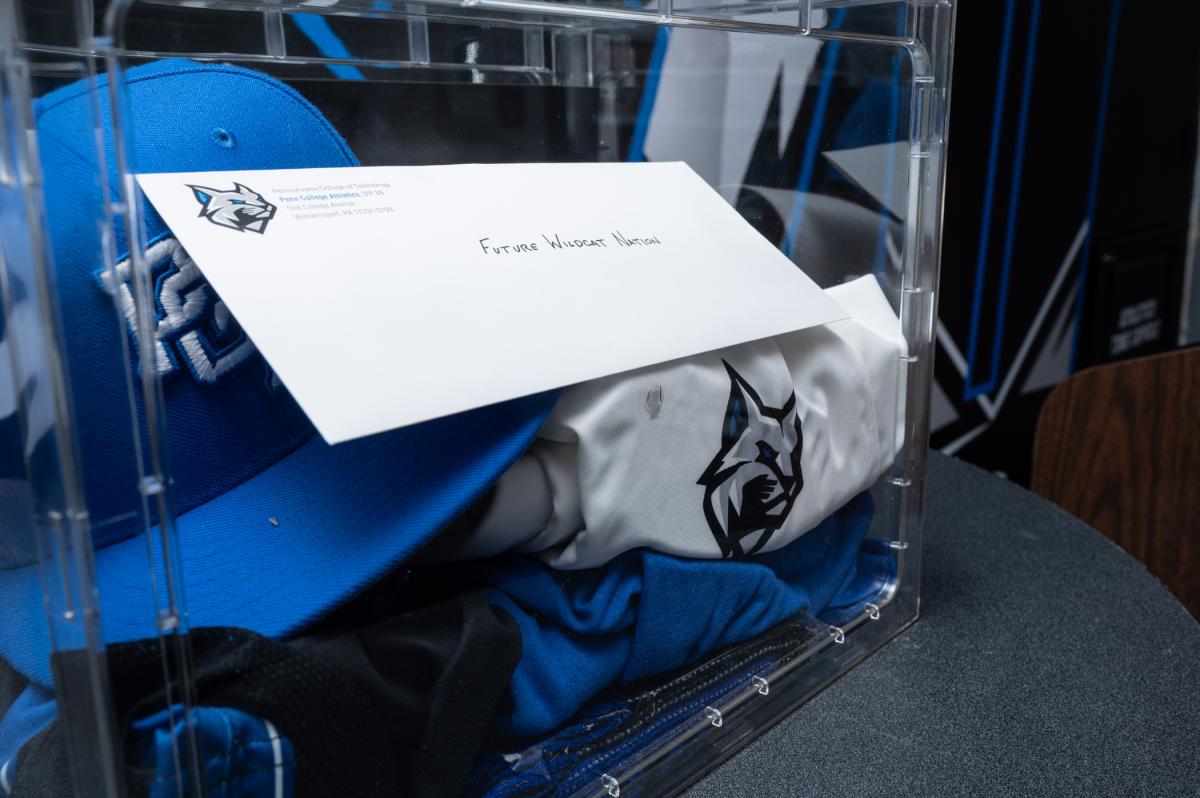 A close-up of the time capsule, a clear box with items inside.