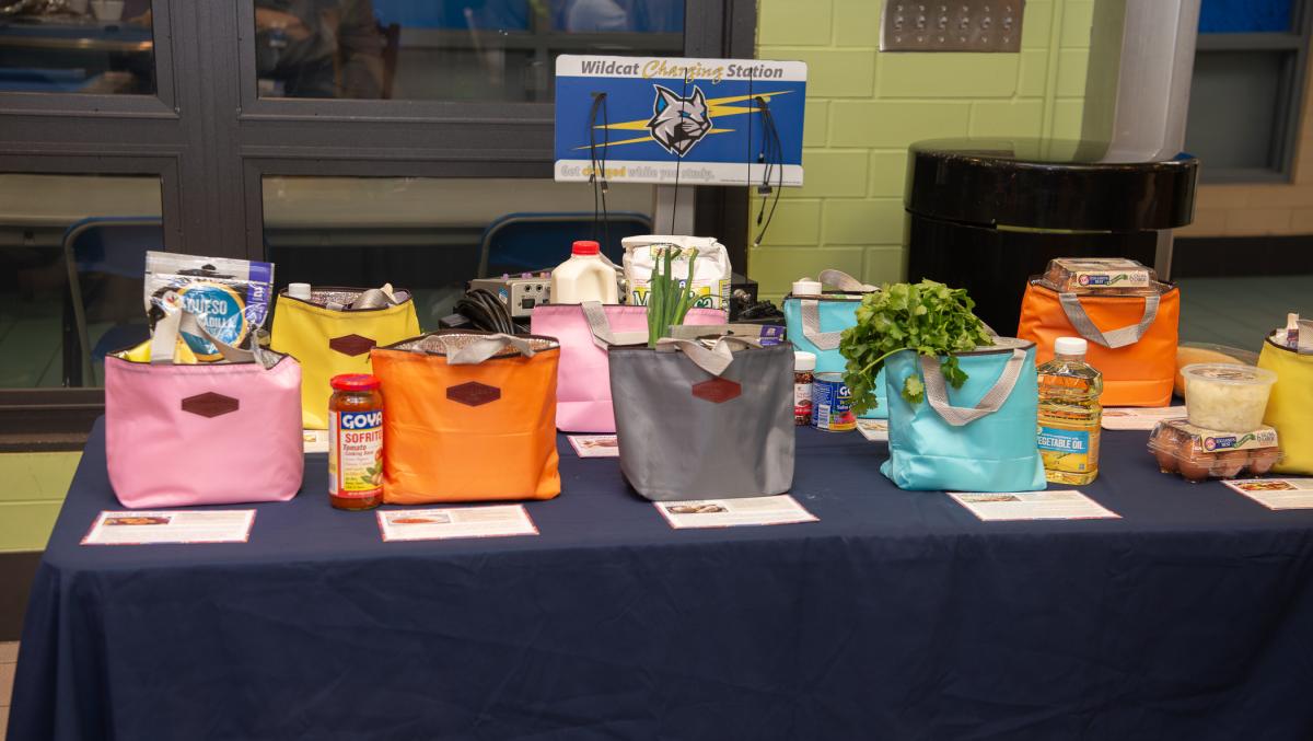 insulated bags filled with ingrediets sit on a table.