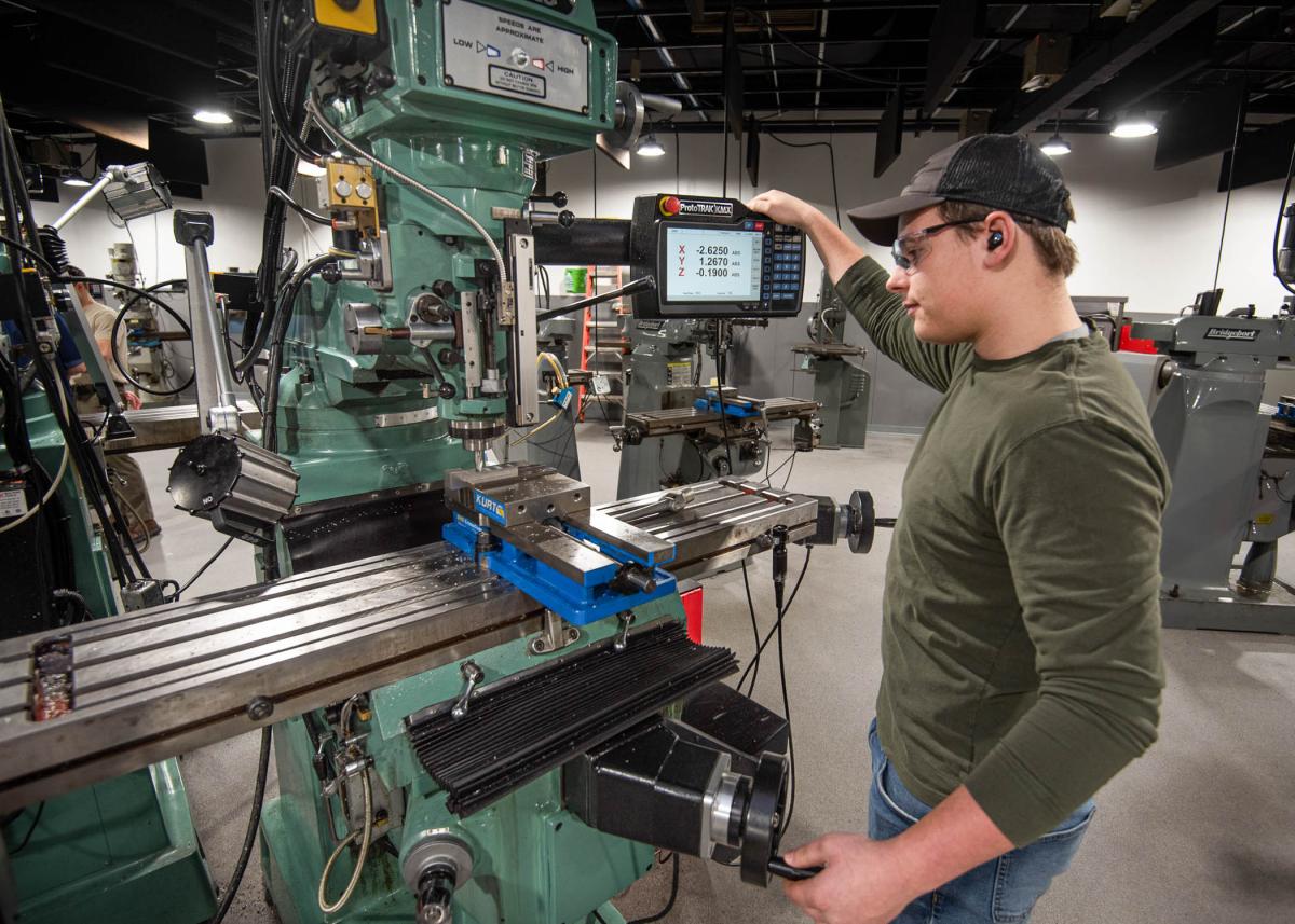 A student operates machining equipment in Penn College's Larry A. Ward Machining Technologies Center.