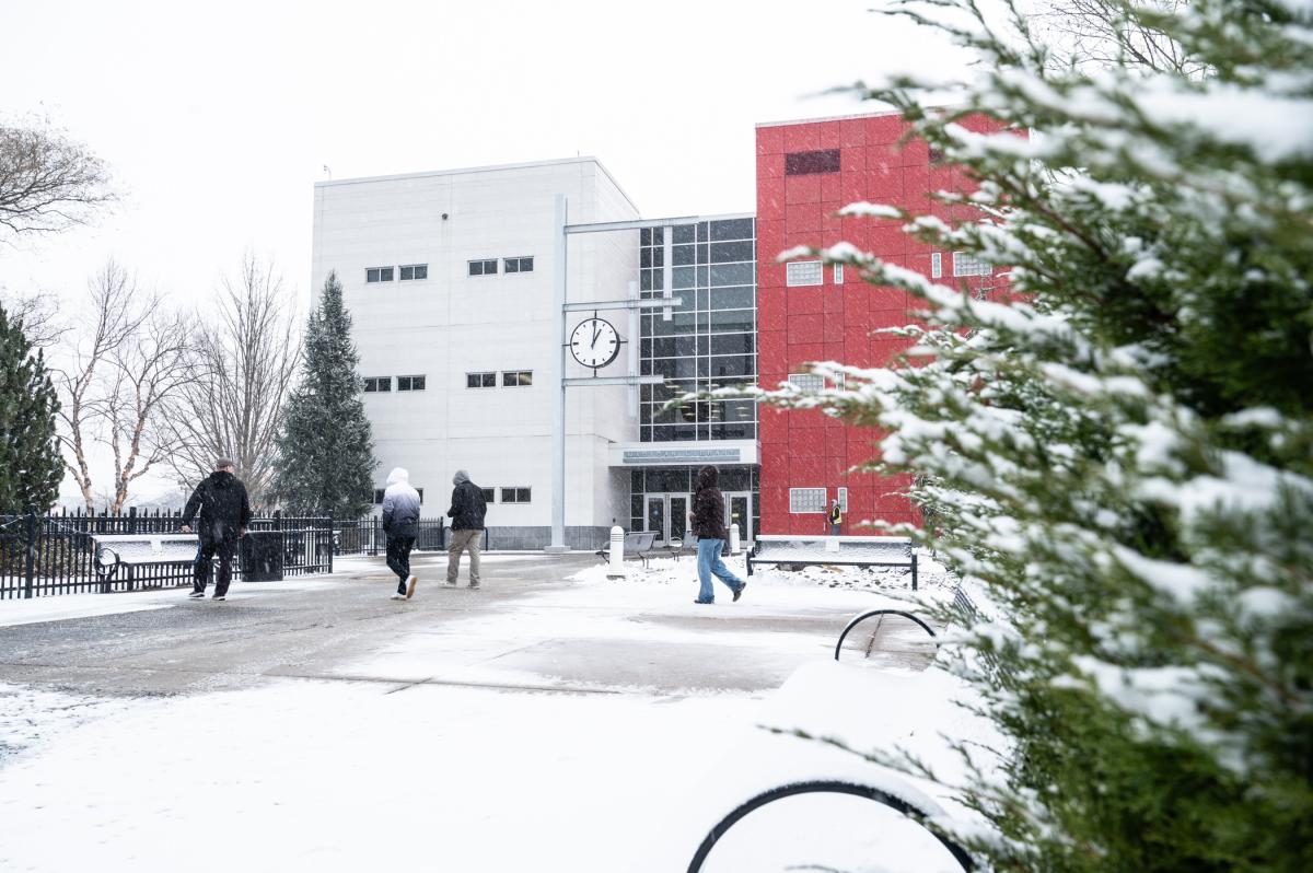 People walk in the snow outside Penn College's Madigan Library.