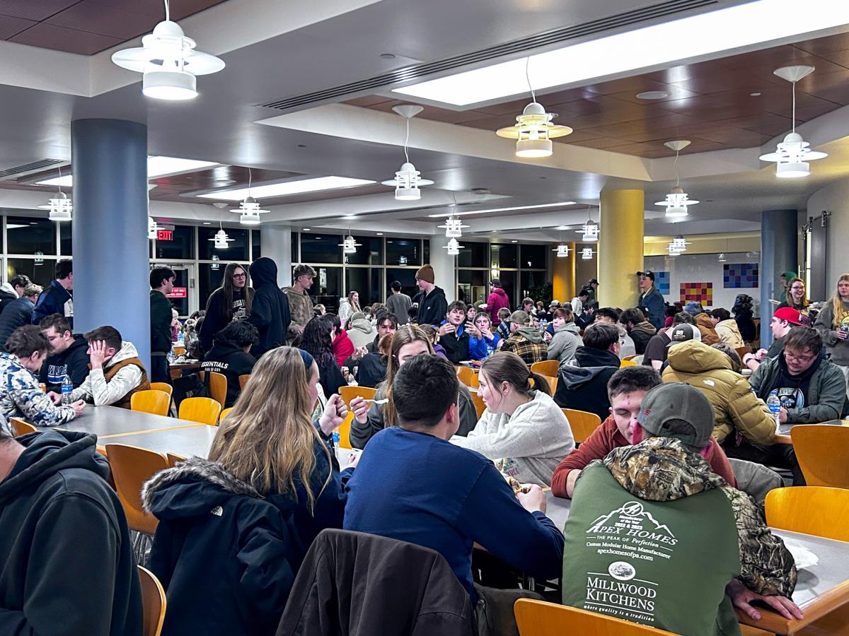 Capitol Eatery dining hall, filled with people sitting at tables and socializing.