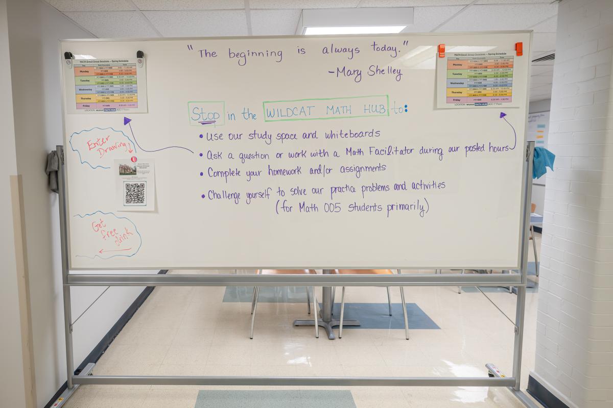 Handwriting on a large whiteboard reads: "The beginning is always today." - Mary Shelly. Stop in the Wildcat Math Hub to: use our study space adn whiteboards, ask a question or work with a math facilitator during our posted hours, complete your homework and/or assignments, challenge yourself to solve our practice problems and actitities (for Math 005 students primarily)