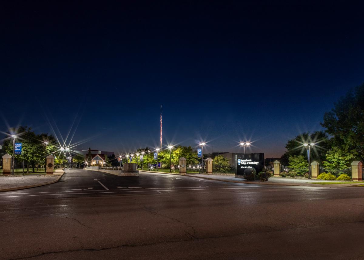 The lighted College entrance at night